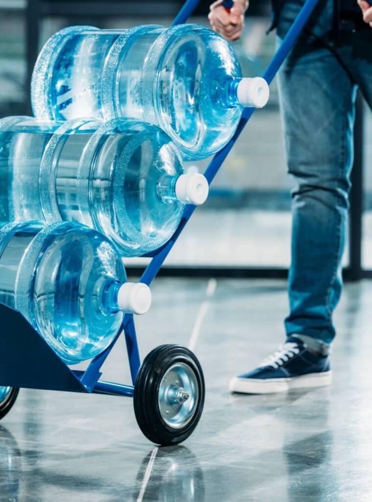 loader-pushing-cart-with-water-bottles.jpg
